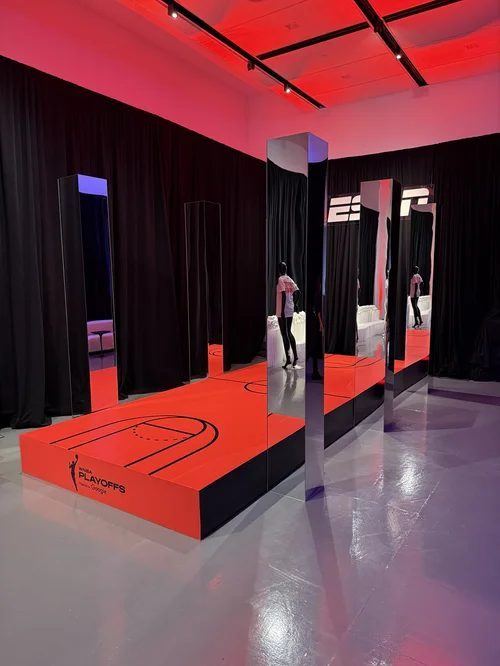 Red runway platform and mirrored installation inside House of ESPN in New York