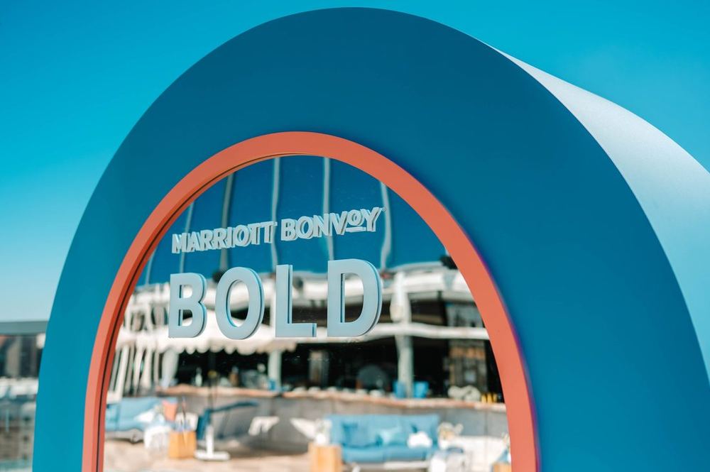 Blue and coral arch framing Marriott Bonvoy BOLD lettering at the rooftop launch event