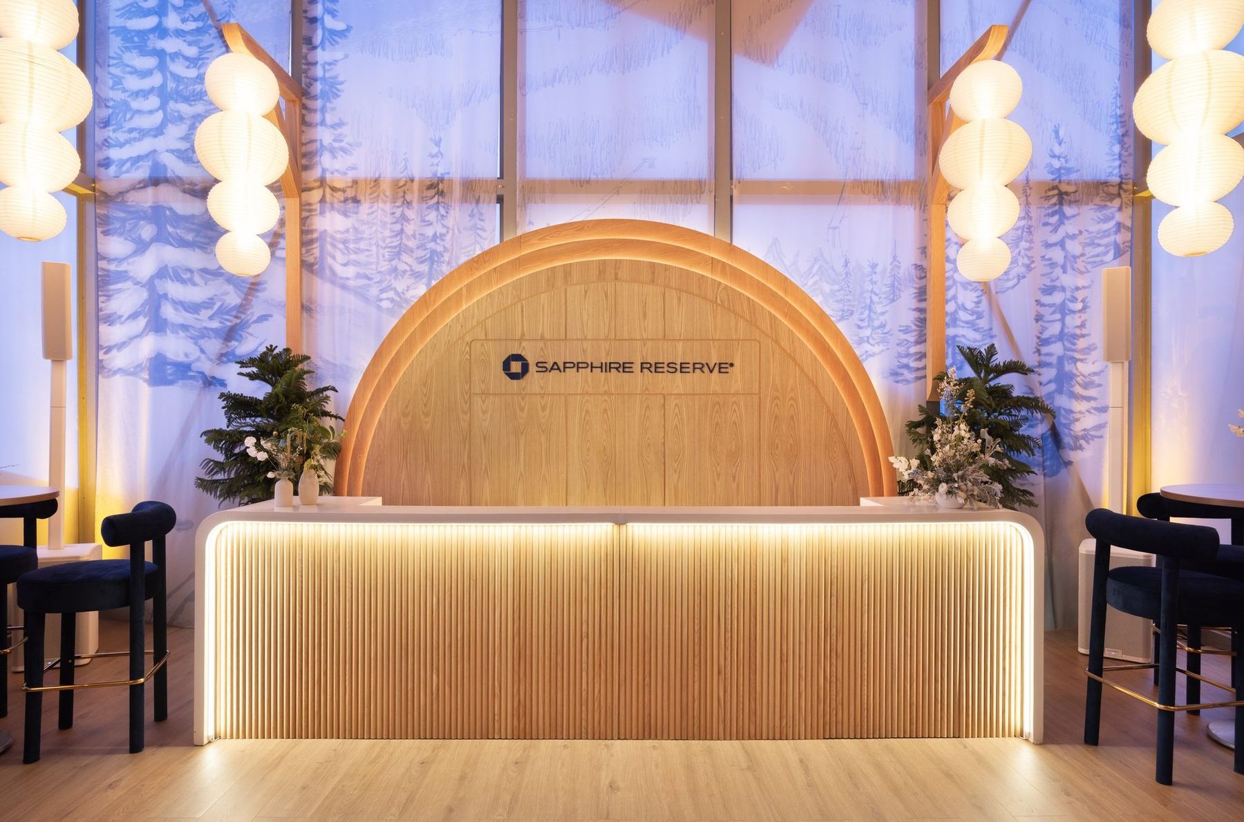 Arched wood bar with the Chase Sapphire Reserve logo, paper lanterns, and frosted windows at the Sundance Film Festival