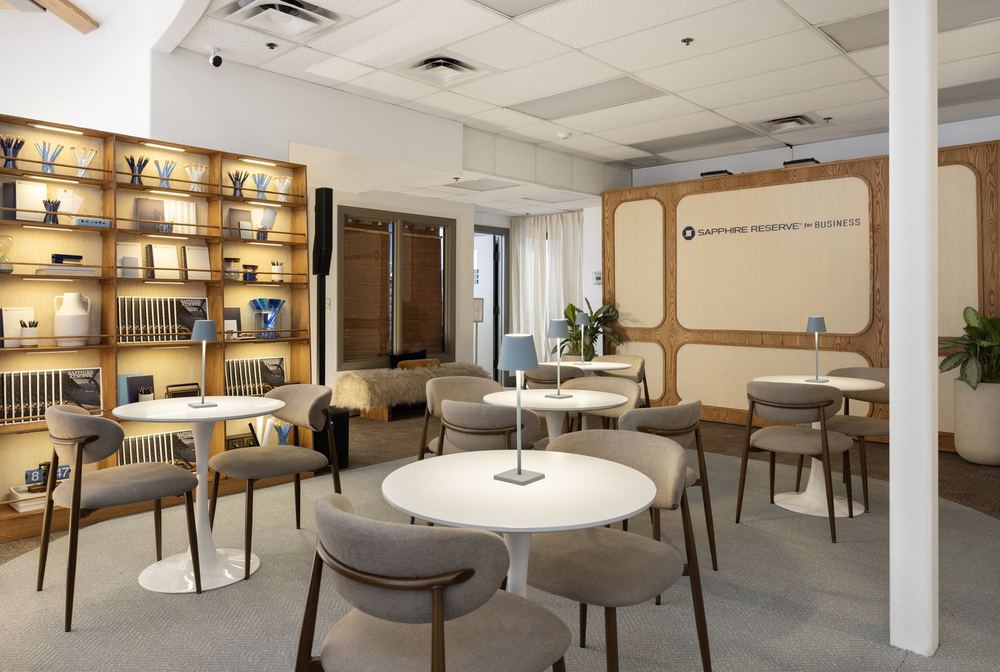 Cafe tables and a lit library wall at the Chase for Business Sundance lounge