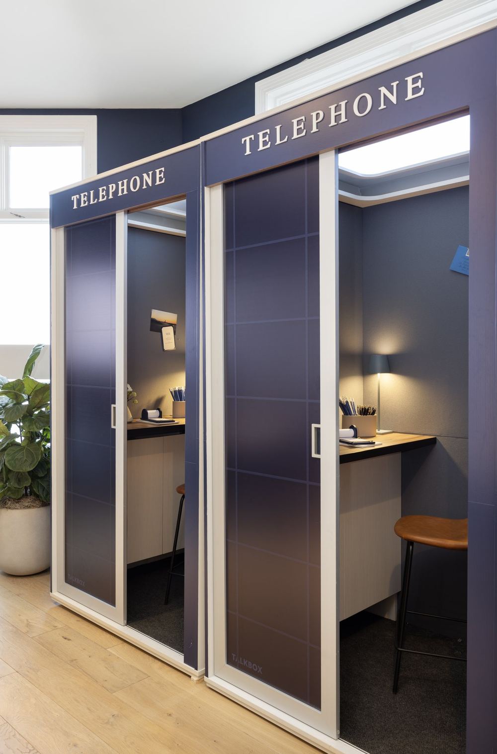 Private navy phone booths for guests at the Chase for Business Sundance lounge